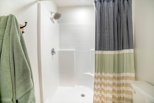 Shower Stall Of A Bathroom With A Tile Pattern Wall Panel