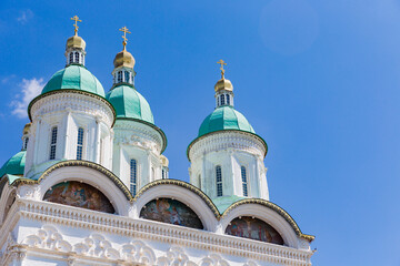 green-blue domes of Cathedral in Astrakhan kremlin with bright blue sky