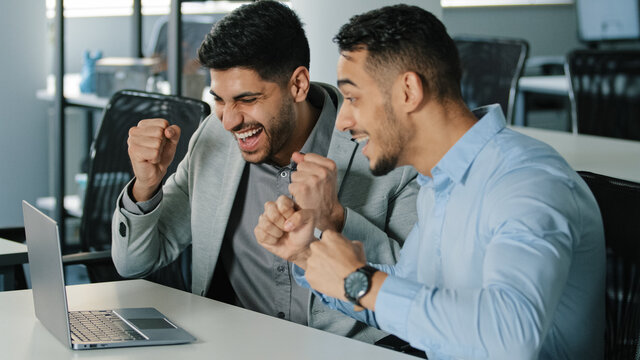 Cheery men celebrate unbelievable notice read on laptop. Career advance, salary growth, commercial special offer happy client, bank mortgage accepted, great news candid emotion, moment of win concept