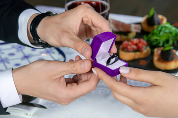 A man gives a woman a smart payment ring.