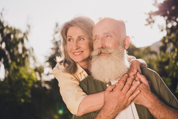 Photo of wife husband happy old man woman piggyback ride hug good mood smile outdoors outside park...