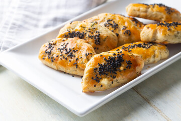 Turkish style pastry with olives and dill cheese pastry (Turkish name; Zeytinli pogaca ve dere otlu peynirli pogaca)