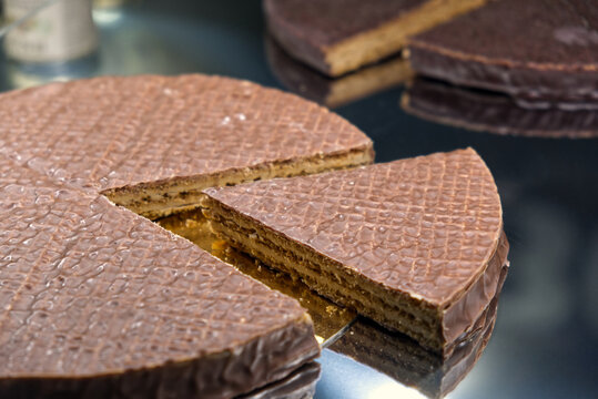 a slice of wafer cake filled with hazelnut cream and covered with milk chocolate