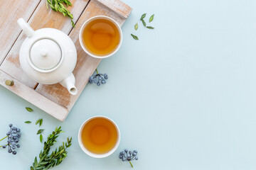 Obraz na płótnie Canvas Two cups of tea with white teapot, top view