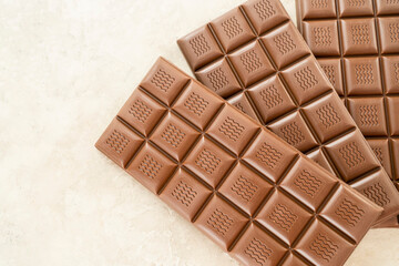 Handmade milk chocolate bar, copy space. Brown bitter craft chocolate on white background. Healthy...