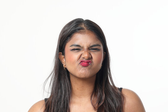 Young attractive Asian Indian woman pose face body expression mode emotion on white background lips kiss