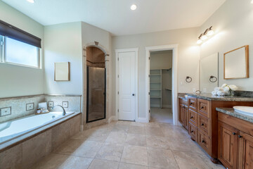 Master bathroom interior with antiqued limestone tiles