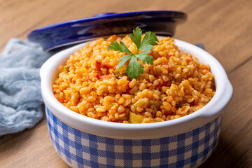 Traditional turkish bulgur pilaf with tomato sause in plate (Turkish name; meyhane pilavi)