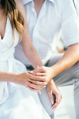 Obraz na płótnie Canvas the bride and groom tenderly hold hands between them love
