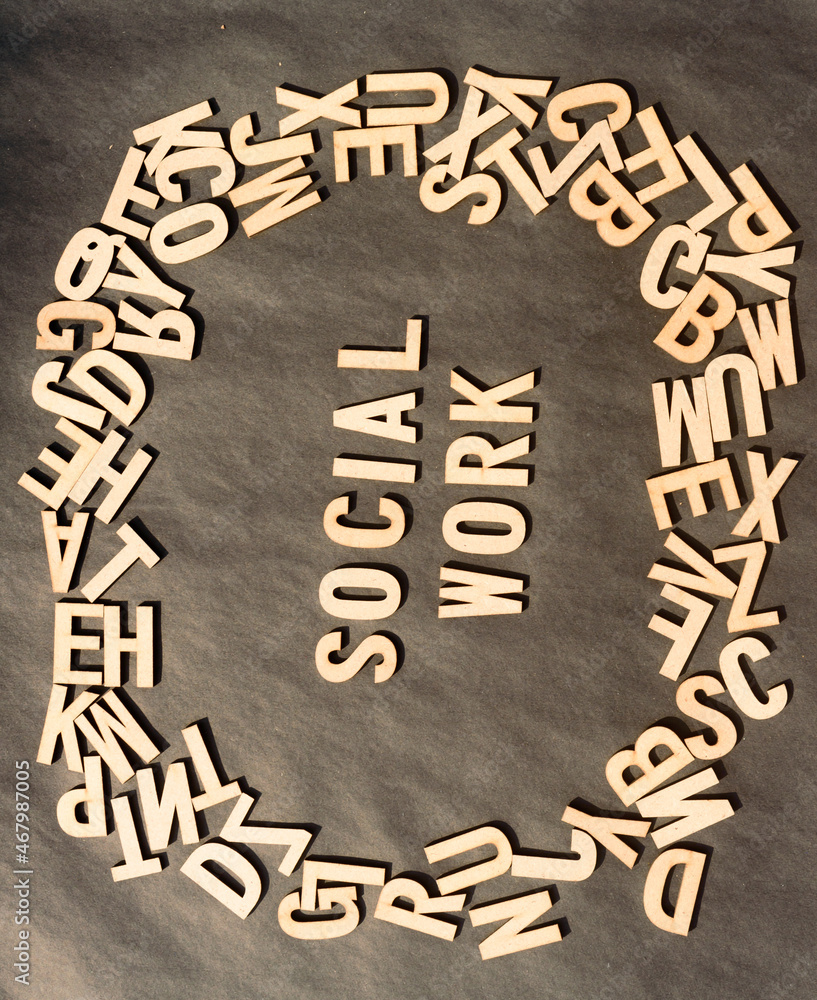 Fototapete work social in wooden cube alphabet letters top view on a rustic paper background.