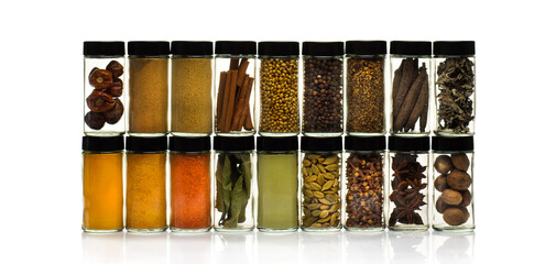 Spices, herbs and seasoning in glass jars on white background