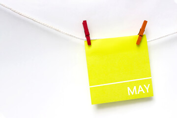 May. Month, Calendar month. Paper cards with calendar day hanging rope with clothespins on white background. Spring , month of the year concept.