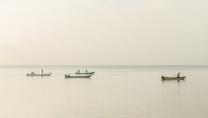 Fototapeta na wymiar Fishermen at sunrise on an island.