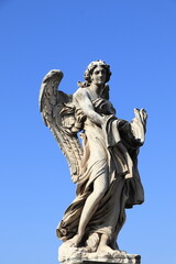 Fototapeta na wymiar Ponte Sant'Angelo Angel with the Garment and Dice Statue in Rome, Italy