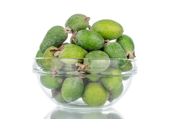 Several organic sweet feijoa fruits with glassware, close-up, isolated on white.