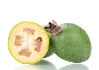 One whole and one half organic sweet feijoa fruit, close-up, isolated on white.