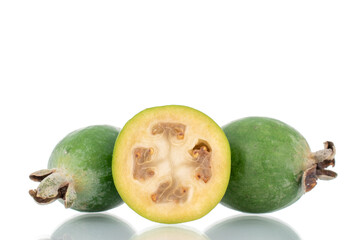 Two whole and one half organic sweet feijoa fruit, close-up, isolated on white.