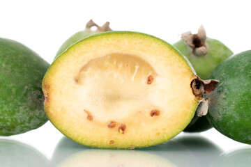 Several whole and one half, in focus, organic sweet feijoa fruit, close-up, isolated on white.