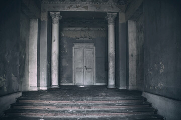 Beautiful interior of an old abandoned manor. Old door and columns. Scary abandoned mansion. Old...