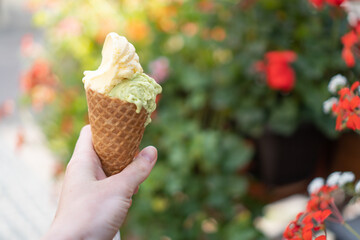 Delision gelato cone on street. Assorted flavor ice creams. Summer ice cream. Melting gelato or melted ice cream cone