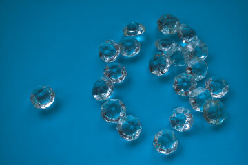 The heart is lined with transparent beads. Background of transparent crystals. Flat picture. Photographed from above. selective focus