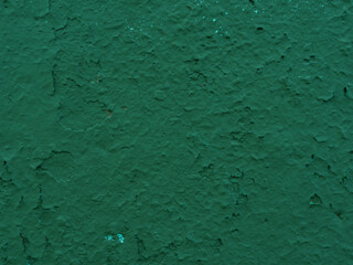 Abstract background of old damaged green plaster on wall.