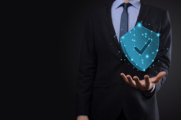 Businessman hold low poly polygon shield with a tick icon.Secure Access System Concept.Business...