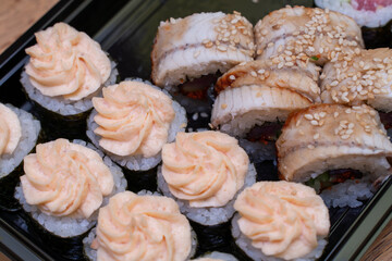 Rolls, sushi on a black background. Dinner.