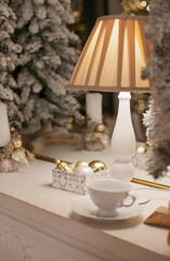 christmas decorations on mantelpiece at home in white gold colors