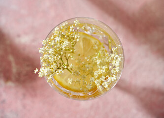 Fresh elder flowers in a glass of homemade lemonade
