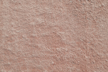 abstract background of an old embossed wall painted light brown close up