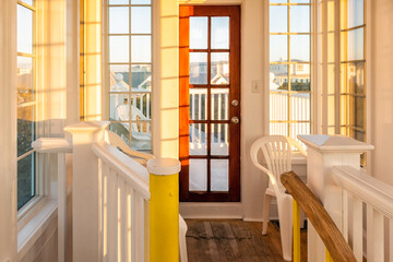 Glass windows and yellow sunlight at sunset in house room tower terrace balcony building interior...
