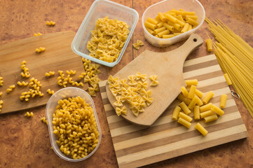 Different types of pasta Cellentani, Tortiglioni, Farfalle, spaghetti are often used in the kitchen for cooking.
