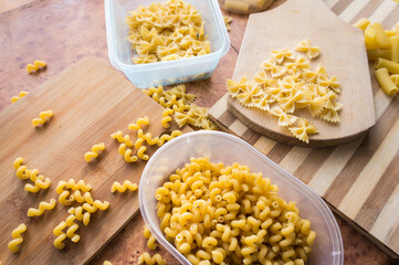 Different types of pasta Cellentani, Tortiglioni, Farfalle, spaghetti are often used in the kitchen for cooking.