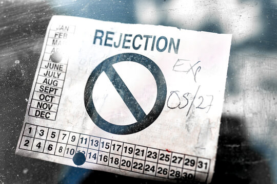 Rejection notice sticker for failing failure of safety state inspection attached to front car vehicle auto windshield window in United States