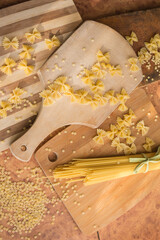 Different types of pasta Cellentani, Tortiglioni, Farfalle, spaghetti are often used in the kitchen for cooking.