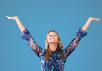 Questioned unaware young girl hands spread sideways
