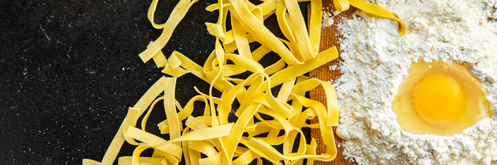 egg pasta raw tagliatelle handmade cooking durum wheat meal on the table copy space food background