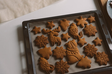 Dusting from a sieve Christmas gingerbread of different shapes animals, snowflakes