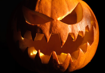 Carved Halloween pumpkin, jack lantern (Jack-o'-lantern). Spooky laughing, scary head in the...