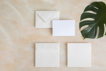 Styled summer wedding desktop stationery mockup. Blank greeting and invitation card. Green tropical leaves with empty space.
