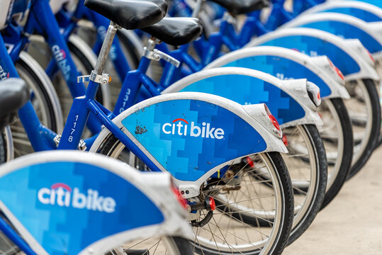 Miami Beach, USA - January 17, 2021: South Beach Lincoln road with closeup of many blue row parked Citi bank citibike bike rack rental bicycles at parking docking station sidewalk street in city