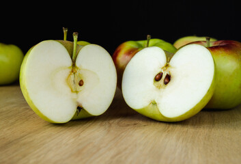 Fresh delicious apples on a wooden kitchen table. Healthy diet food fruits composition.