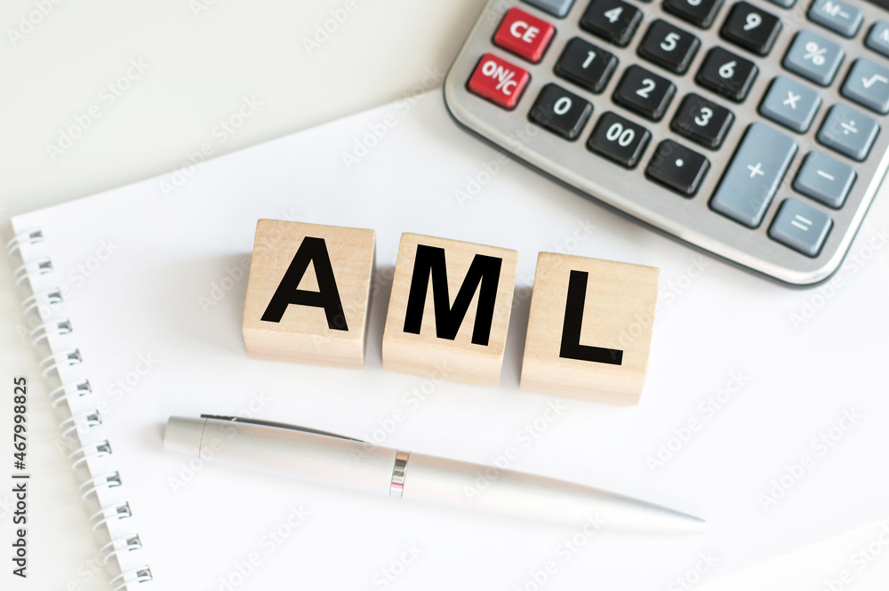 Poster aml word concept written on wooden cubes on table with notepad and calculator