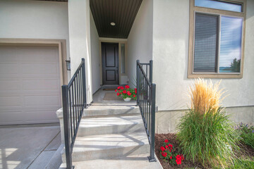 Entrance of a house in the middle of the walls with stairs and railings