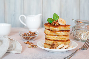 Breakfast with pancakes on a light background.