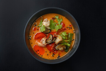 tom yam on a black background