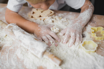 Close-up of children's hands all in flour. Cooking concept at home with kids.
