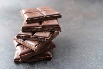 Sweet Chocolate tower pieces chocolates. Stack of chocolate pieces. Background with chocolate. recipe Cooking handmade chocolate bar, dessert, candies