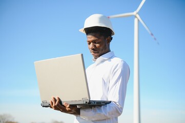 Engineer African man standing with wind turbine